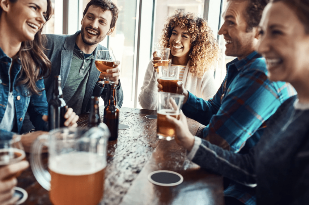 diverse group of friends enjoying happy hour at the bar